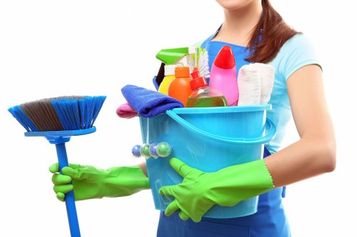 Staff member in PPE preparing carpet cleaning equipment